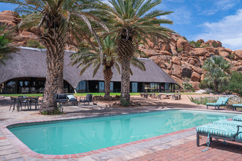 Outdoor pool & sunbeds at Ai Aiba Rock Painting Lodge, Erongo Mountains, Namibia.