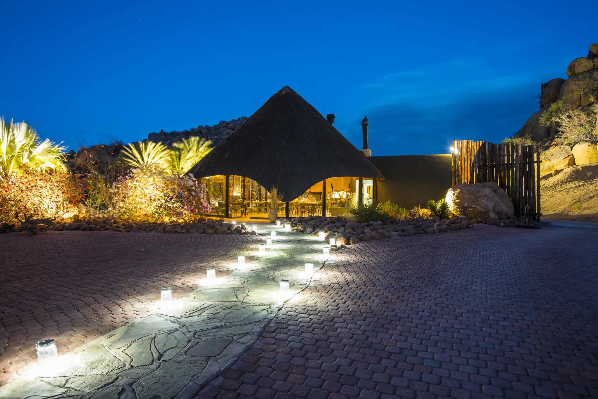 Lit pathway from chalets to restaurant at Ai Aiba Rock Painting Lodge, Erongo Mountains, Namibia.