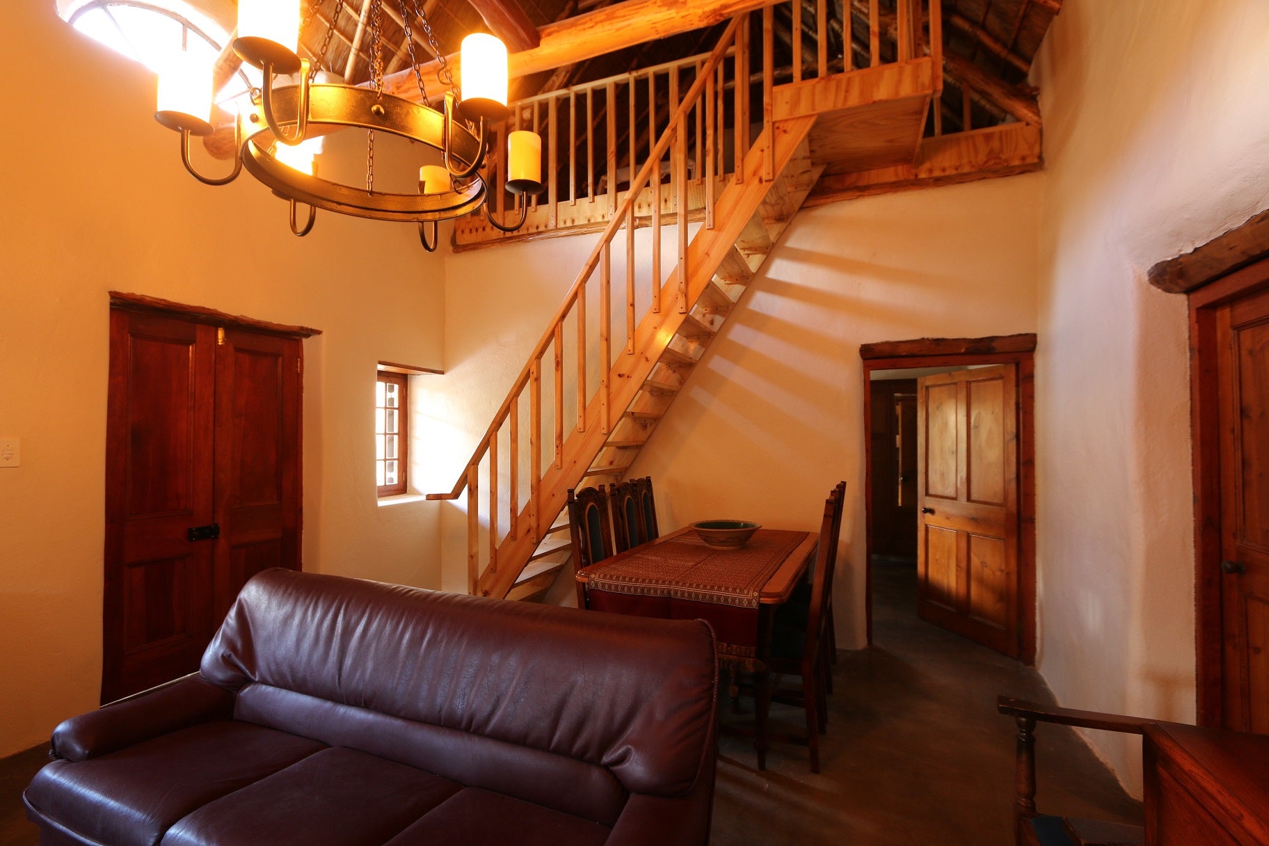 Dining area and Staircase to the upper room with two single beds.