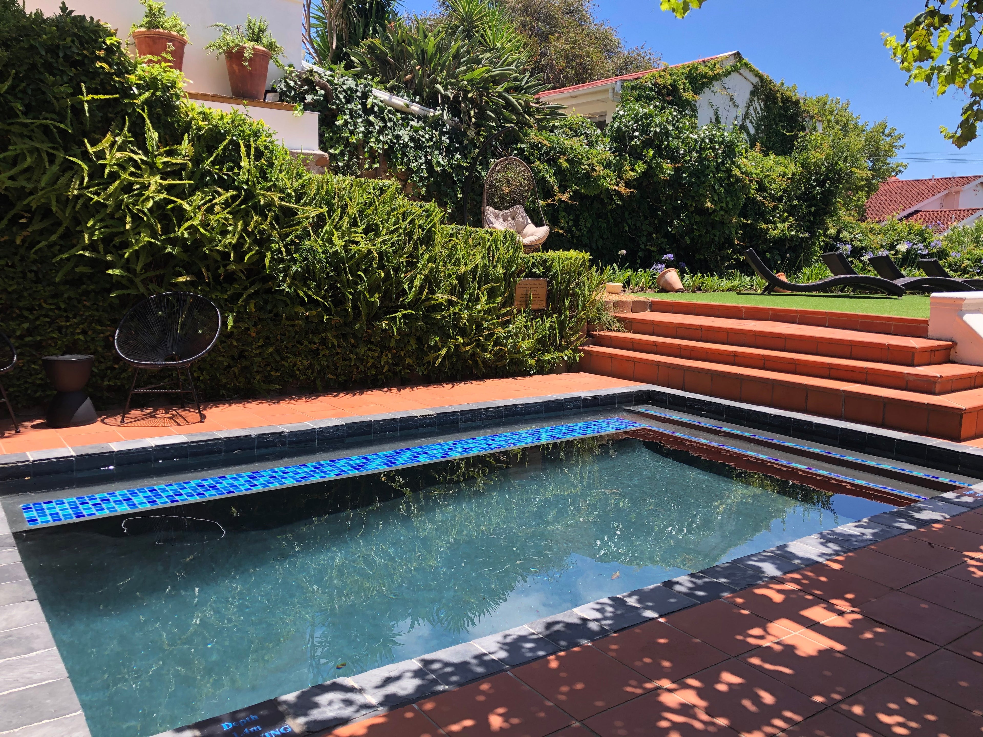 The pool, egg chairs and lounging deck
