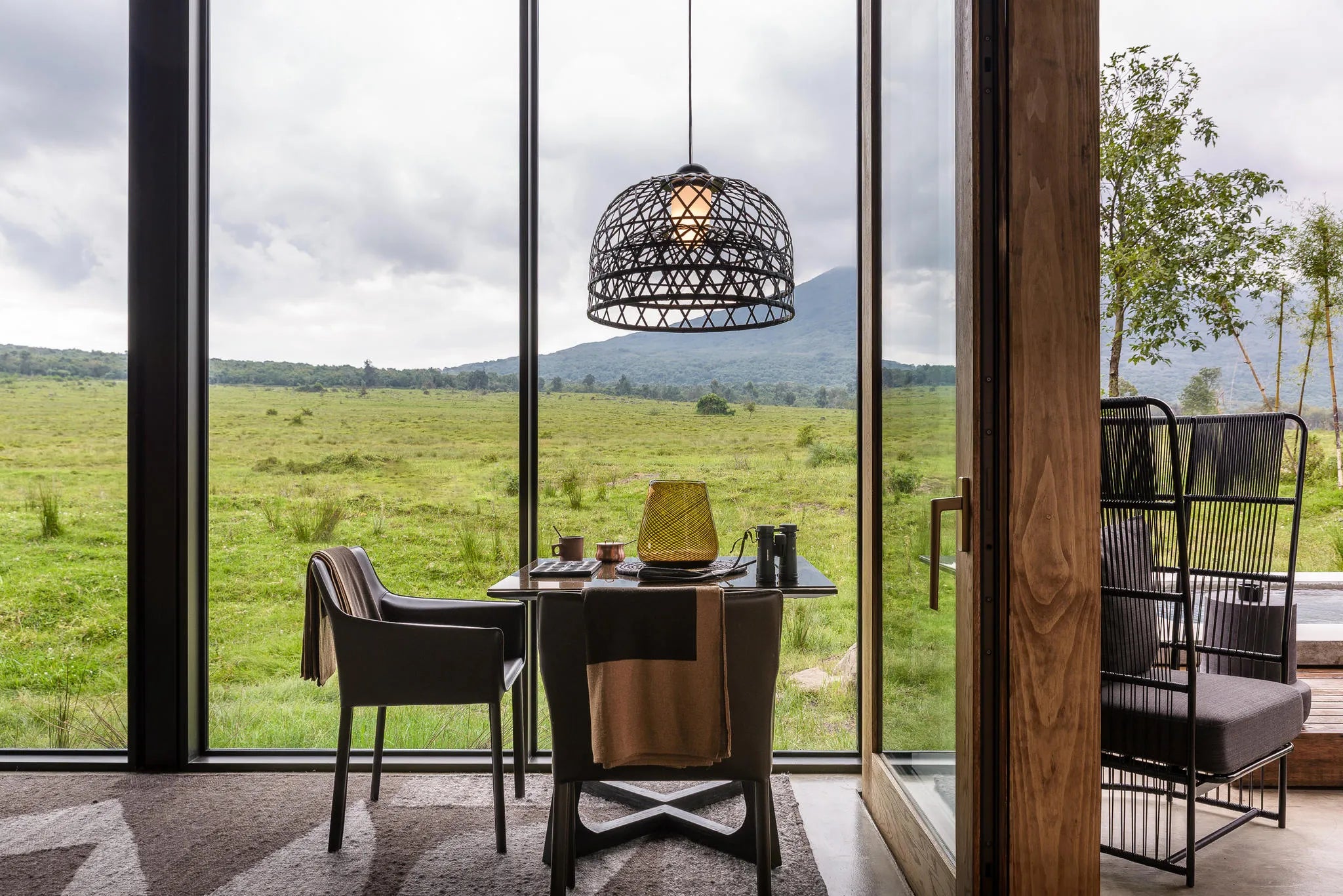 Singita Kwitonda Lodge - Dining with a View at Singita Kwitonda Lodge, Volcanoes National Park, Rwanda.