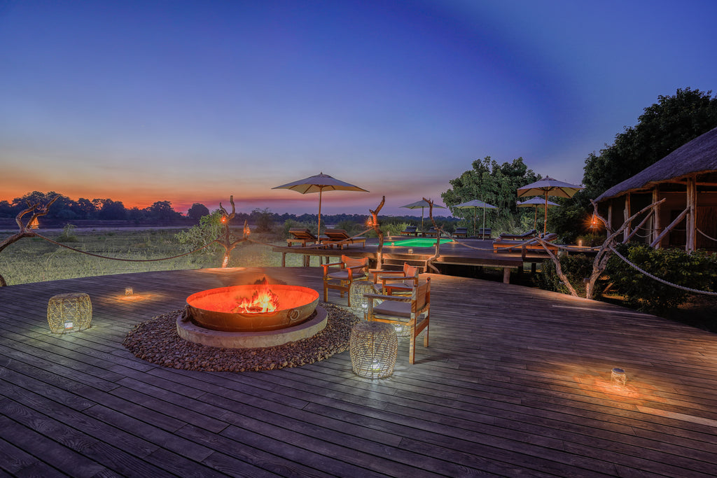 Evening at Chikunto - firepit and pool, Luangwa in backfround