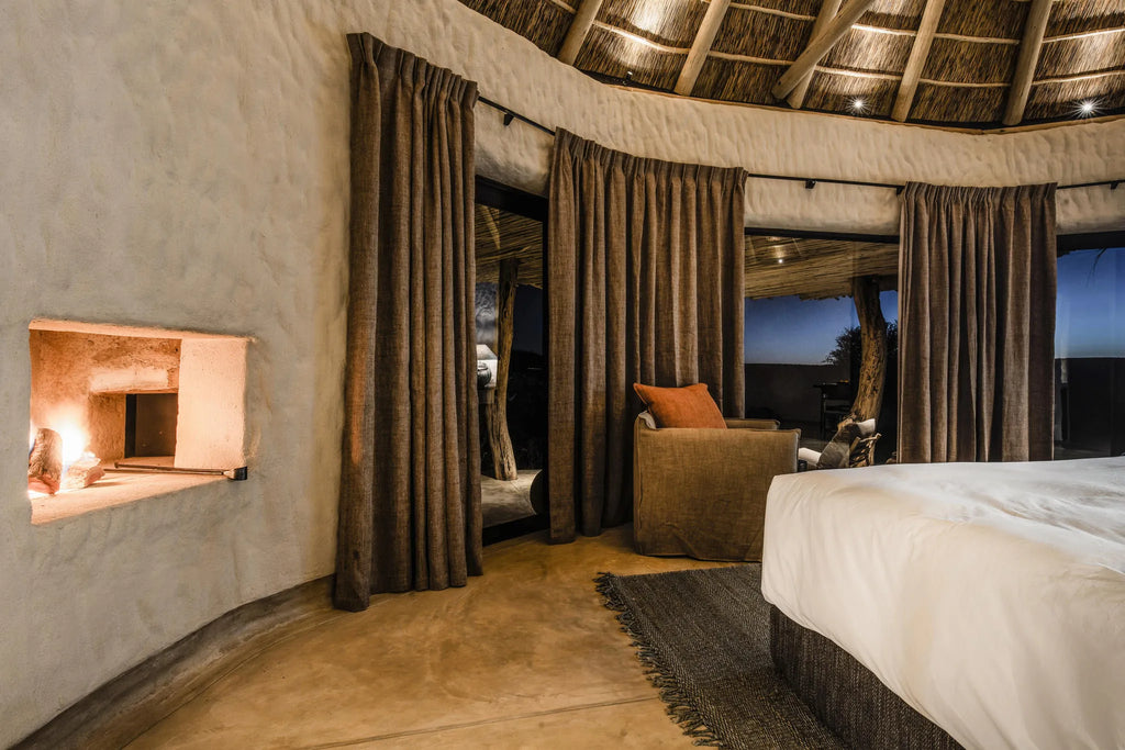 Bedroom with fireplace at Zannier Omaanda, Zannier Reserve, Namibia.