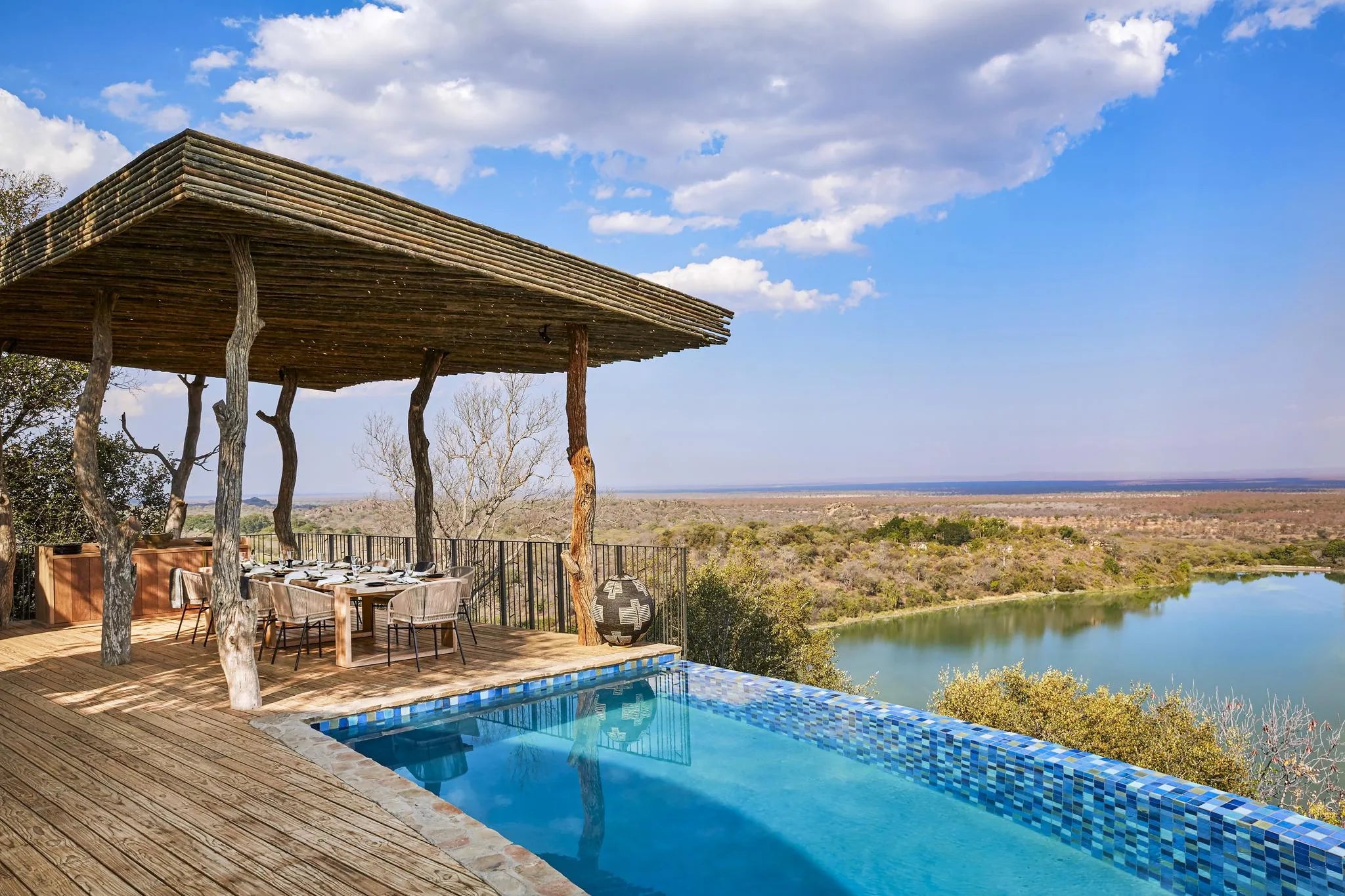 Singita Malilangwe House - Family dining and pool with a view at Singita Malilangwe House, Malilangwe Wildlife Reserve, Zi...