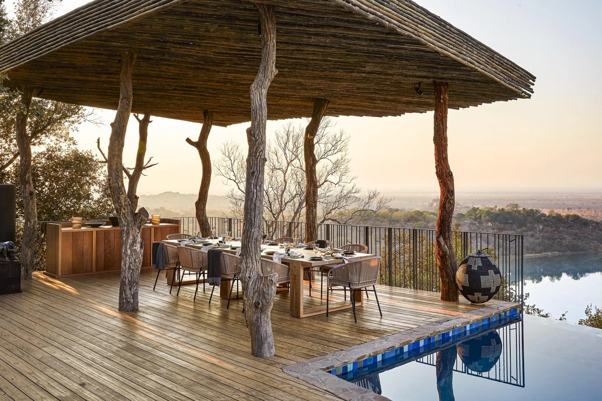 Singita Malilangwe House - Family dining on the deck at Singita Malilangwe House, Malilangwe Wildlife Reserve, Zimbabwe.