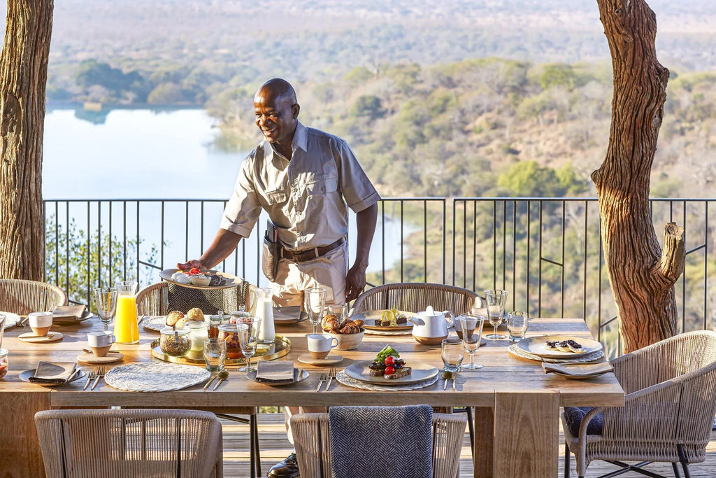 Singita Malilangwe House - Family lunch and waiter at Singita Malilangwe House, Malilangwe Wildlife Reserve, Zimbabwe.