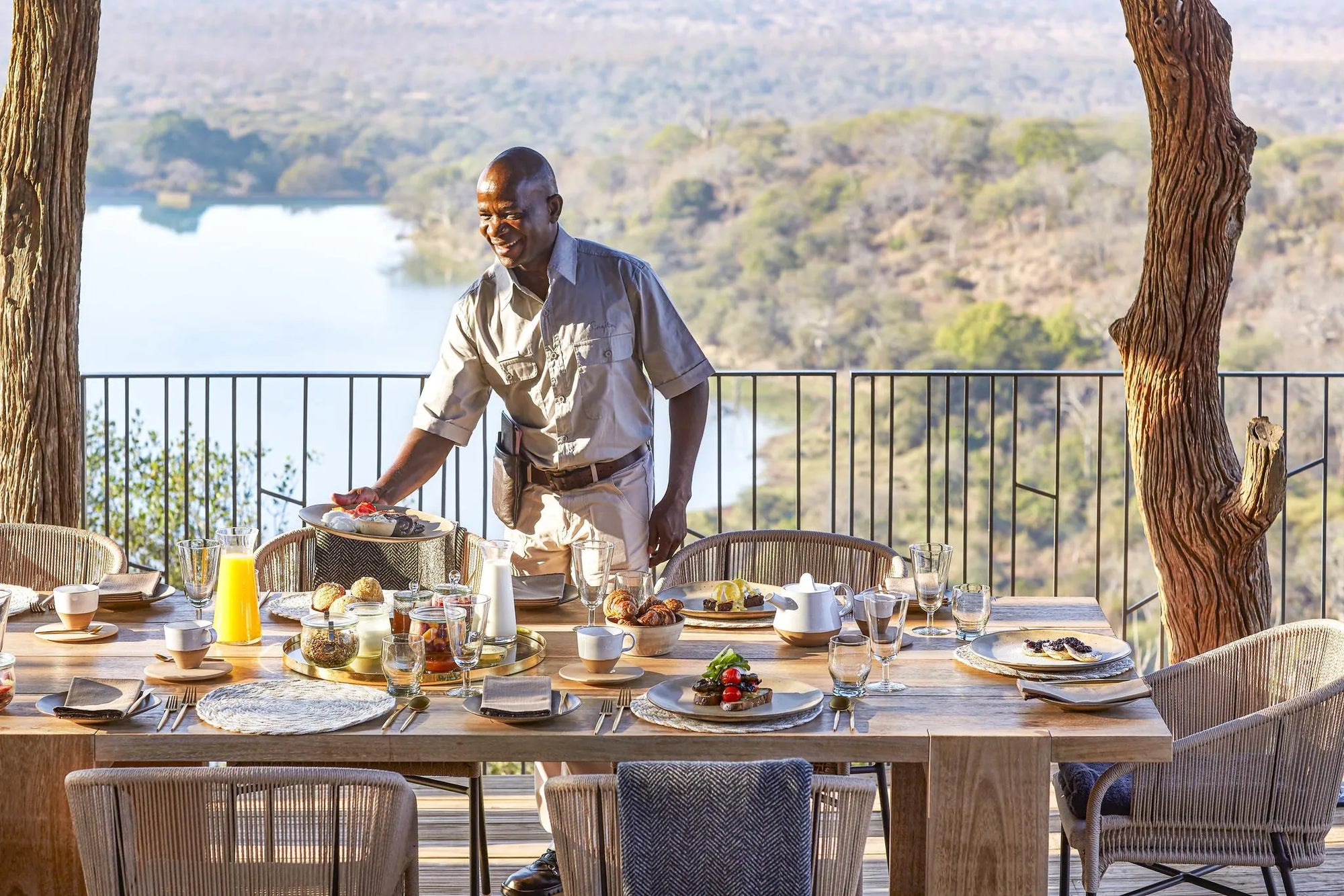 Singita Malilangwe House - Family lunch and waiter at Singita Malilangwe House, Malilangwe Wildlife Reserve, Zimbabwe.