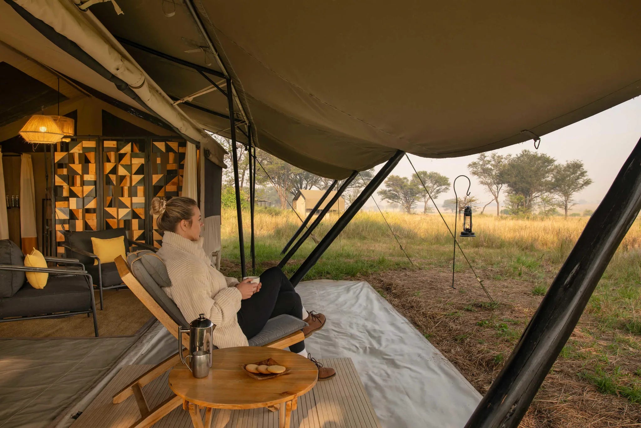 Ubuntu Camp - Guest enjoying a morning coffee at Ubuntu Migration Camp - North (June - Nov), Northern Serengeti, Tanzania.