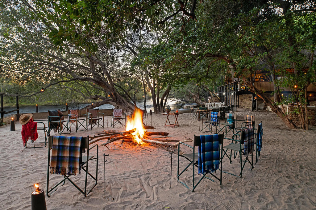 Fire pit setup with beach dinner at Ichingo Chobe River Lodge by Mantis, Impalila Island, Namibia.