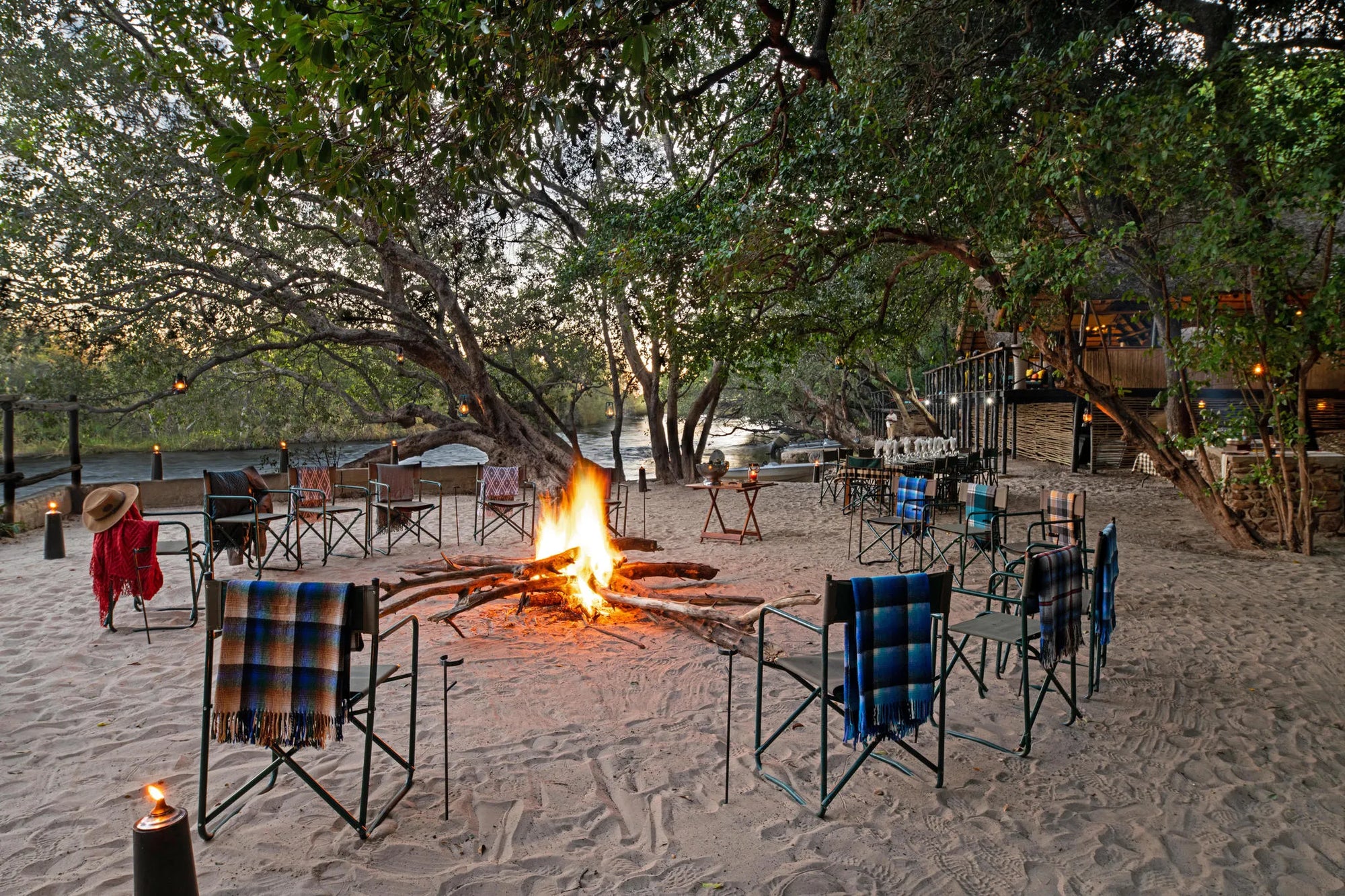 Fire pit setup with beach dinner at Ichingo Chobe River Lodge by Mantis, Impalila Island, Namibia.