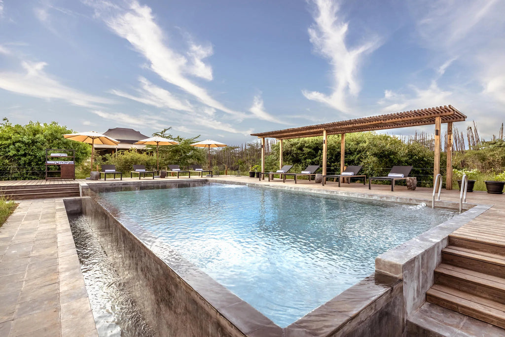 Poolside relaxation at JW Marriott Masai Mara Lodge, Masai Mara, Kenya.