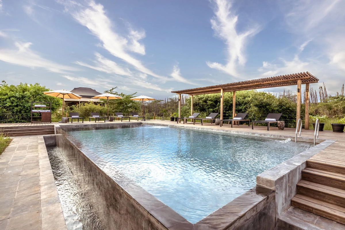 Poolside relaxation at JW Marriott Masai Mara Lodge, Masai Mara, Kenya.