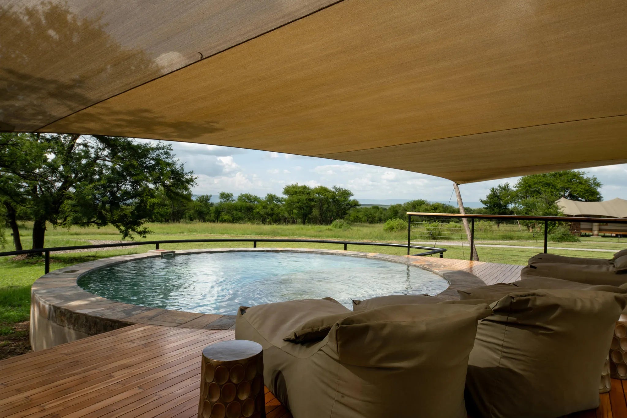 Asilia Africa - Sayari Retreat - Loungers at Swimming Pool in shared Main Area at Retreats at Sayari, Northern Serengeti, ...