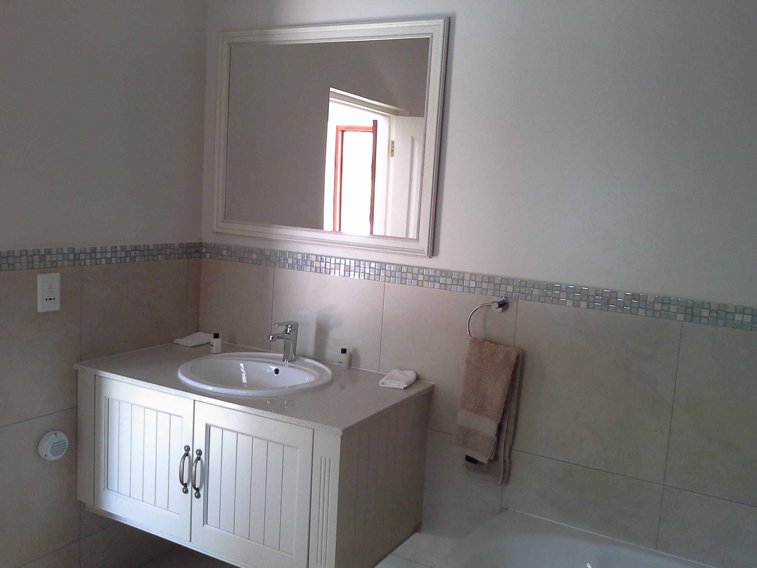 Spacious modern bathroom with large shower.