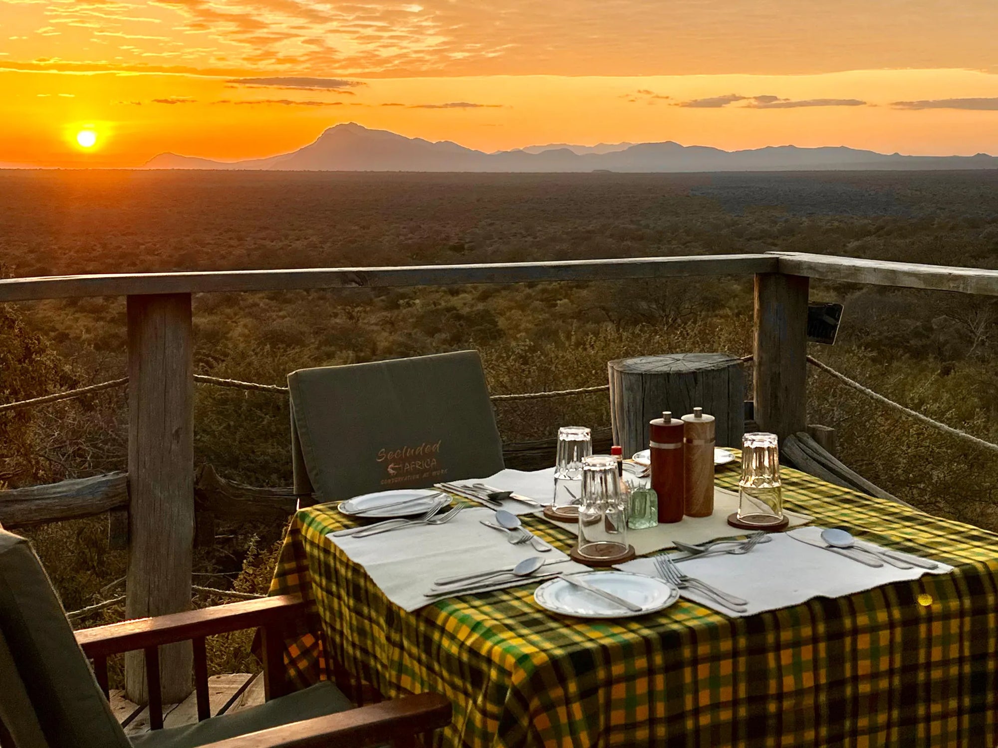 Kipalo Hills, Dinner at pool deck with view to the waterhole at Kipalo Hills, Tsavo West National Park, Kenya.