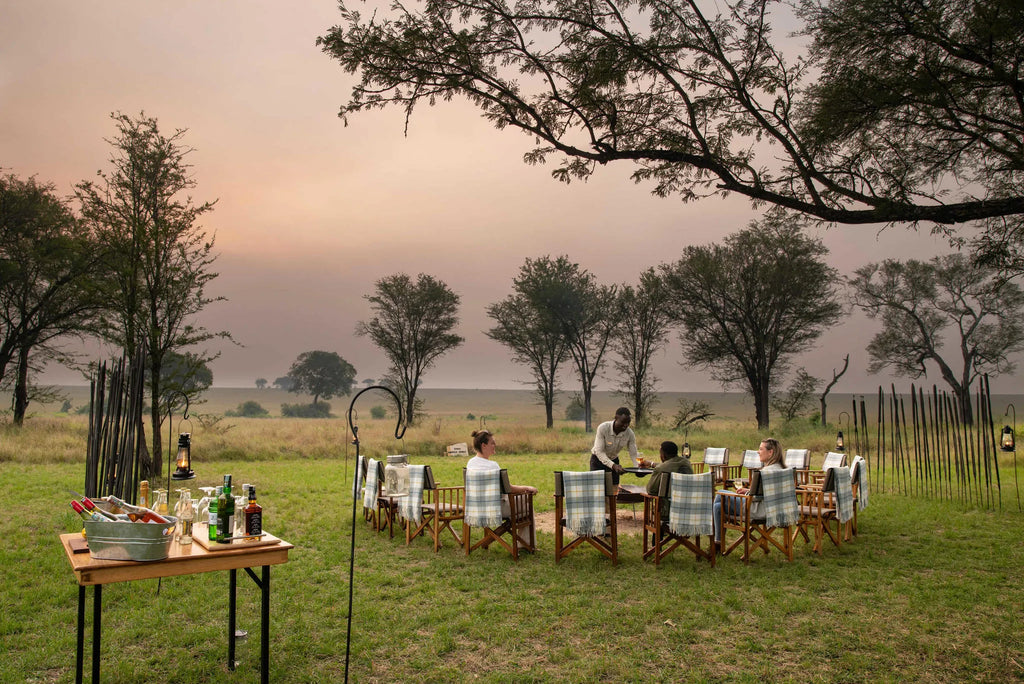 Ubuntu Camp - Guests enjoying sundowners at Ubuntu Migration Camp - South (Dec - Mar), Southern Serengeti, Tanzania.