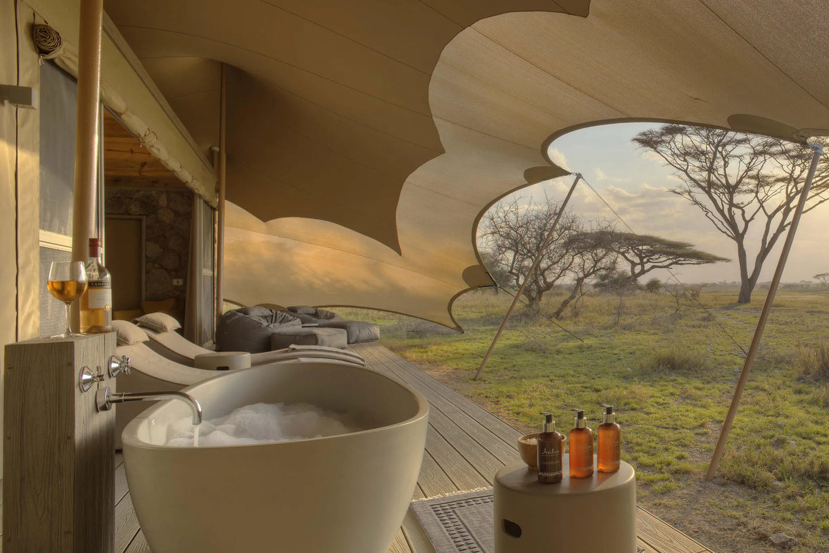 Namiri Plains - Tent Deck with Bath, Sunbeds and Cushion Corner at Namiri Plains Camp, Eastern Serengeti, Tanzania.