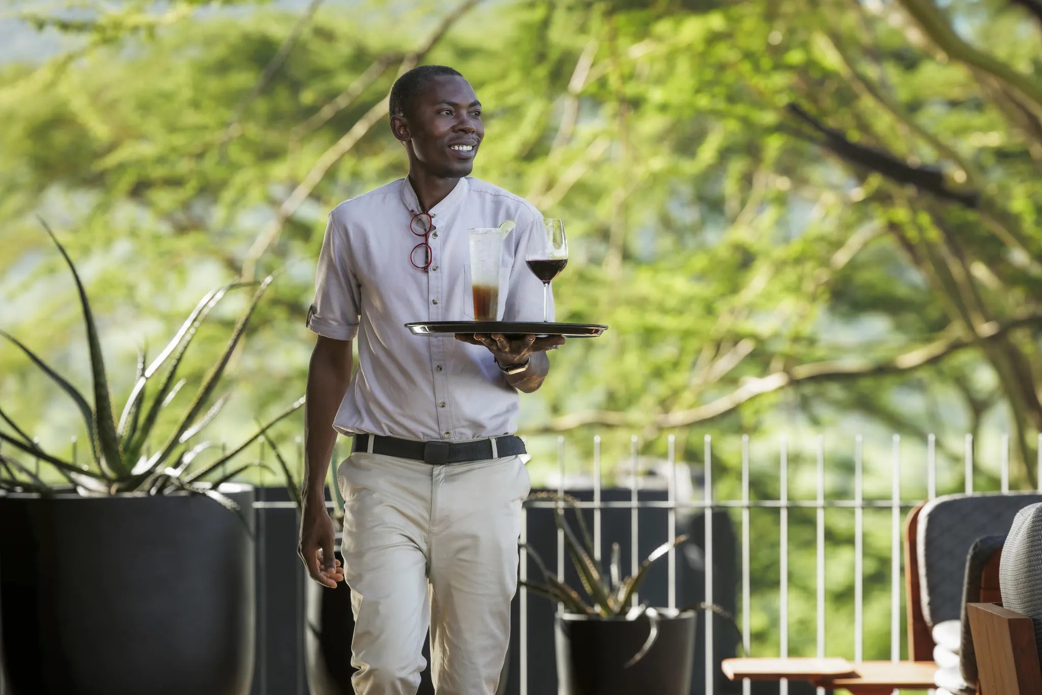 Portrait Waiter With Tray at Serengeti Explorer by Elewana Collection, Seronera, Tanzania.