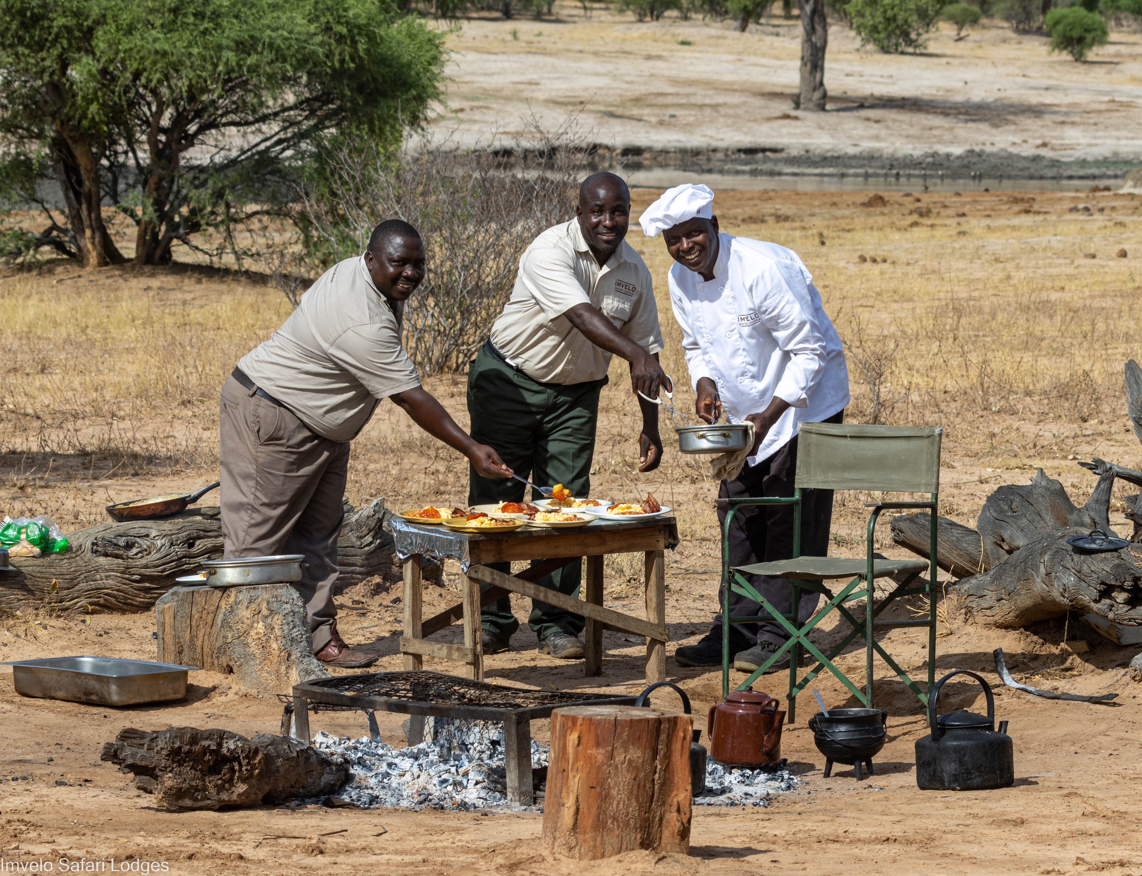 Camp staff preparing a hearty meal