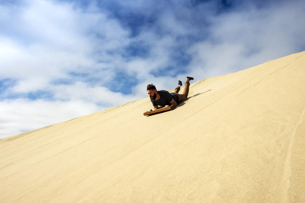 Sandboarding at Shipwreck Lodge, Skeleton Coast, Namibia.