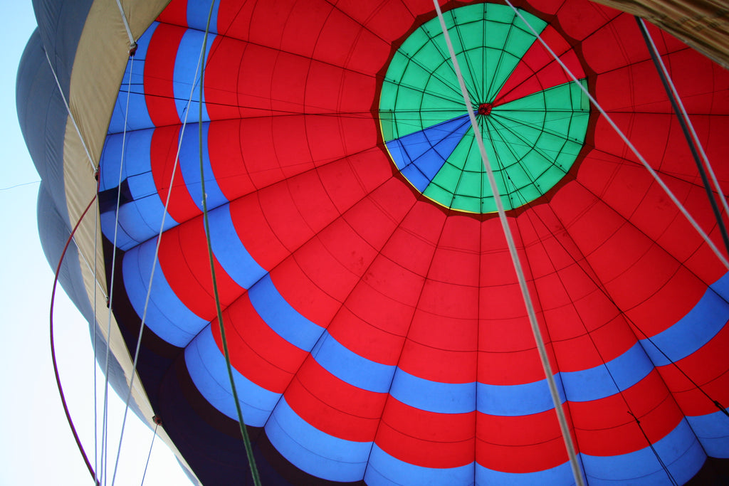 View upwards from the basket at the colourful balloon canopy