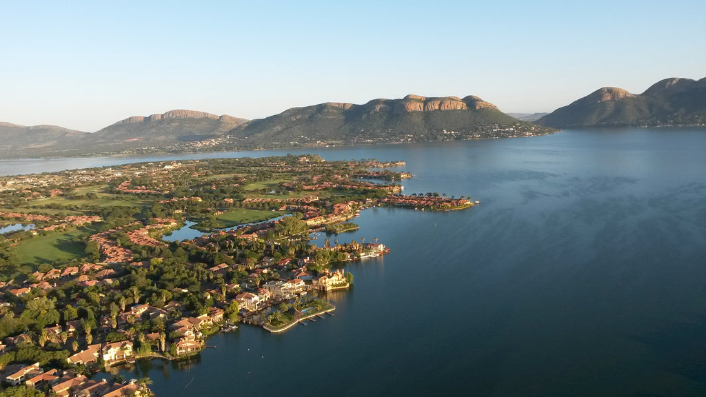 View across Hartbeespoort Dam from the balloon with majestic Magalies mountains in the background