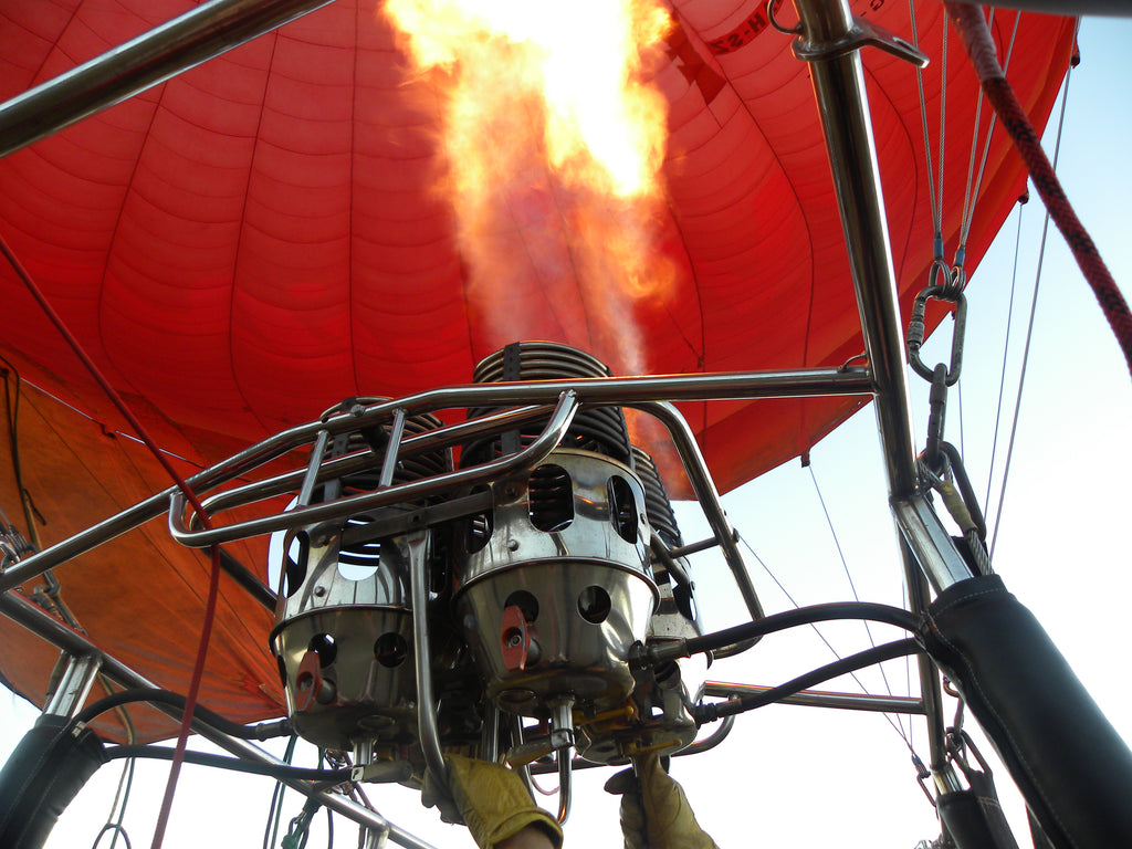 The powerful burners of the balloon heat up the air inside the balloon to give it lift