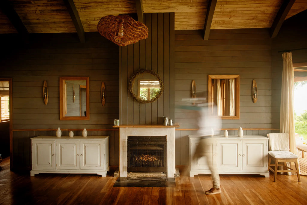 A waiter walks past the warming fire in the dining area at Entamanu Ngorongoro, Ngorongoro Crater, Tanzania.