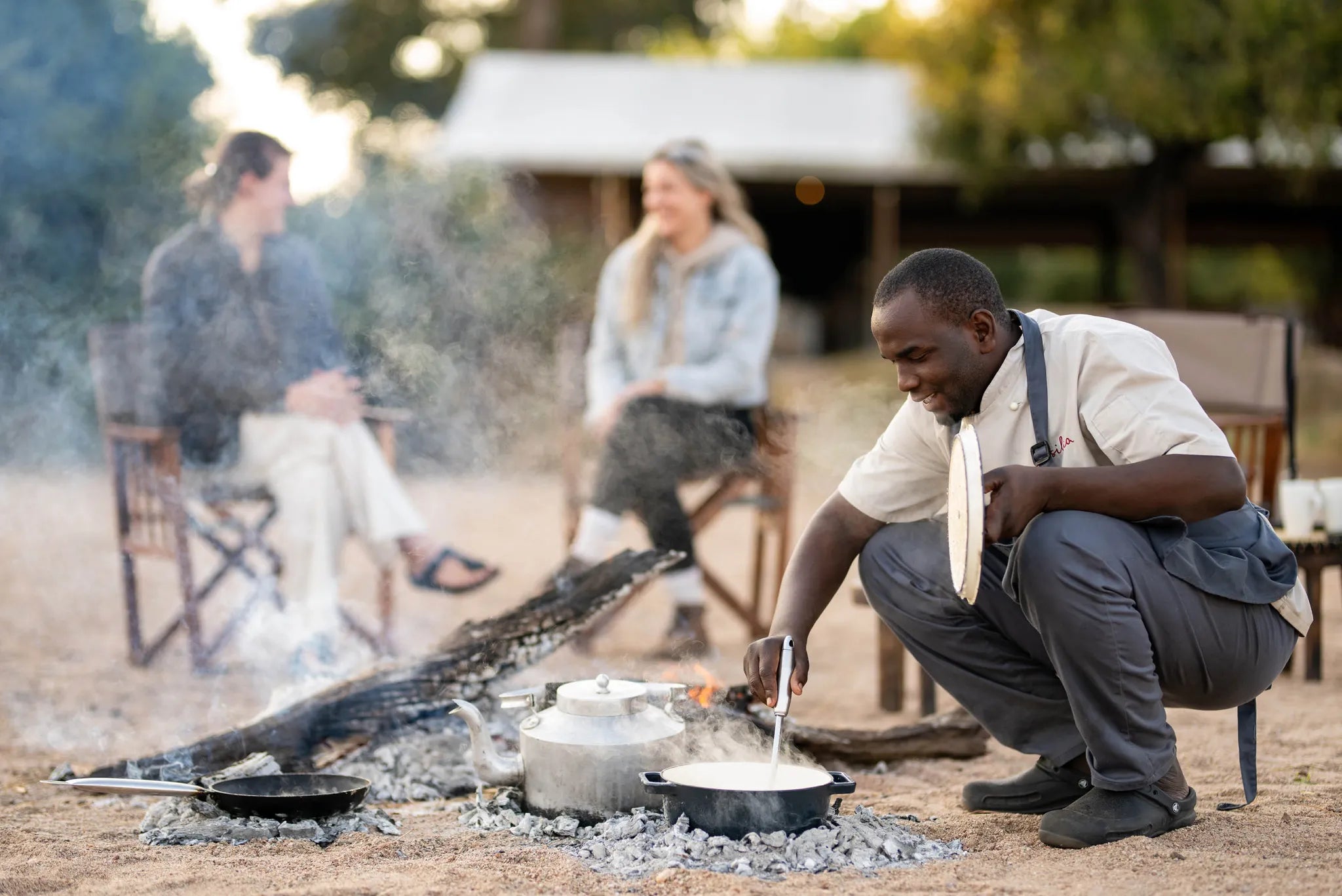 Kokoko - Breakfast Around the Fire at Kokoko Camp, Ruaha National Park, Tanzania.