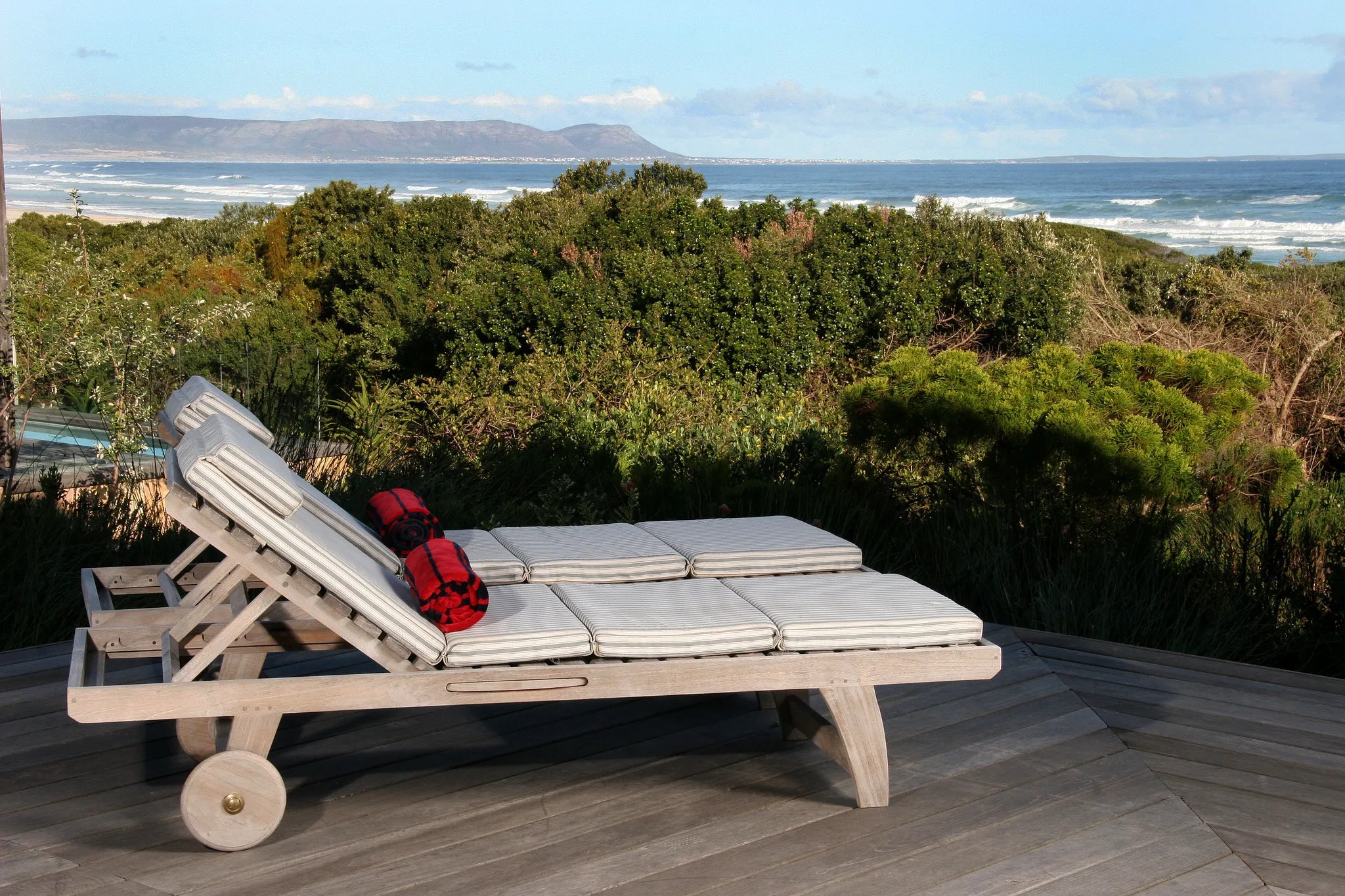 Seafacing Deck overlooking our natural Fynbos garden and the ocean at Mosselberg on Grotto Beach, Hermanus, South Africa.