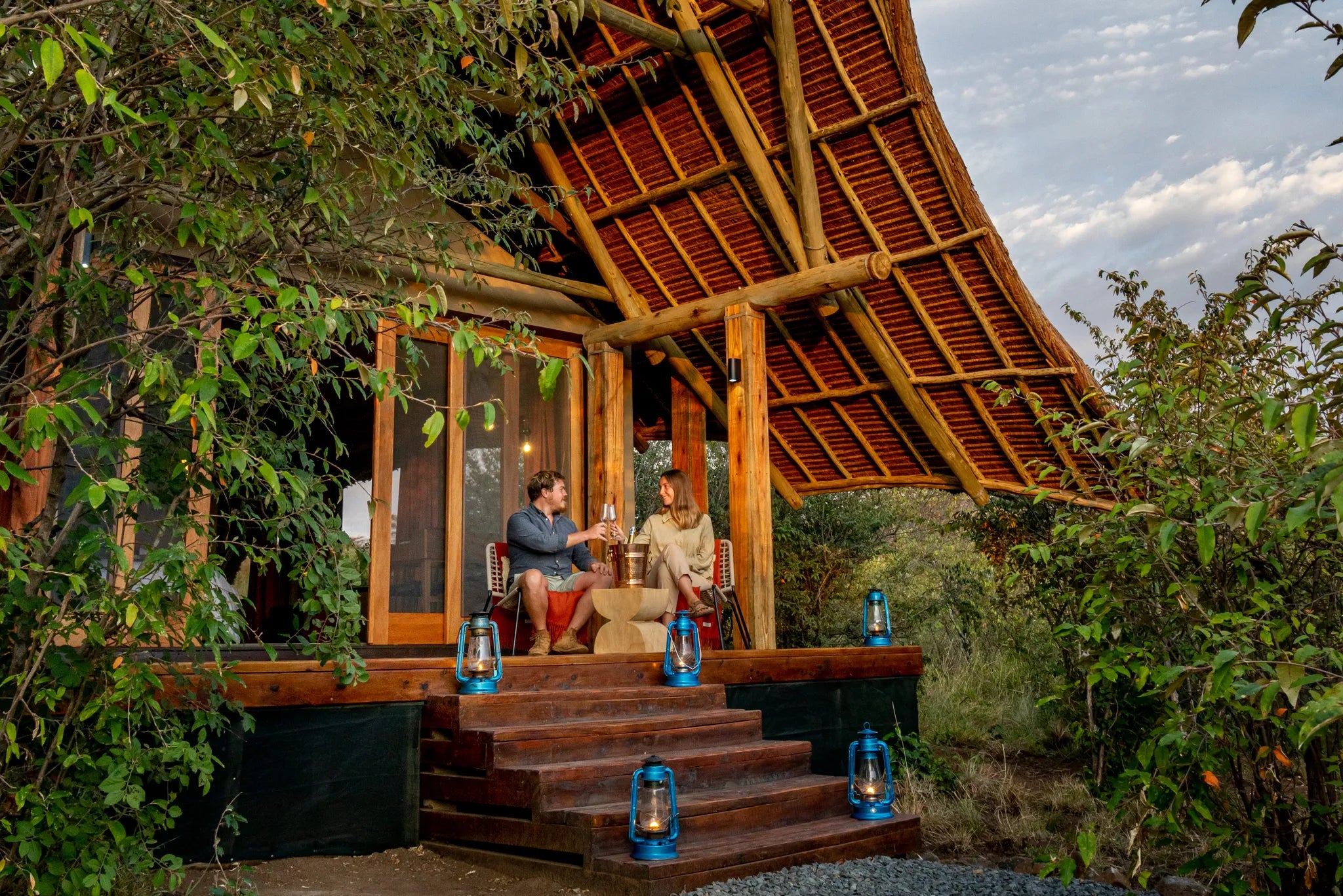 Naboisho Camp - Guests relaxing on tent deck at Naboisho, Mara Naboisho Conservancy, Kenya.