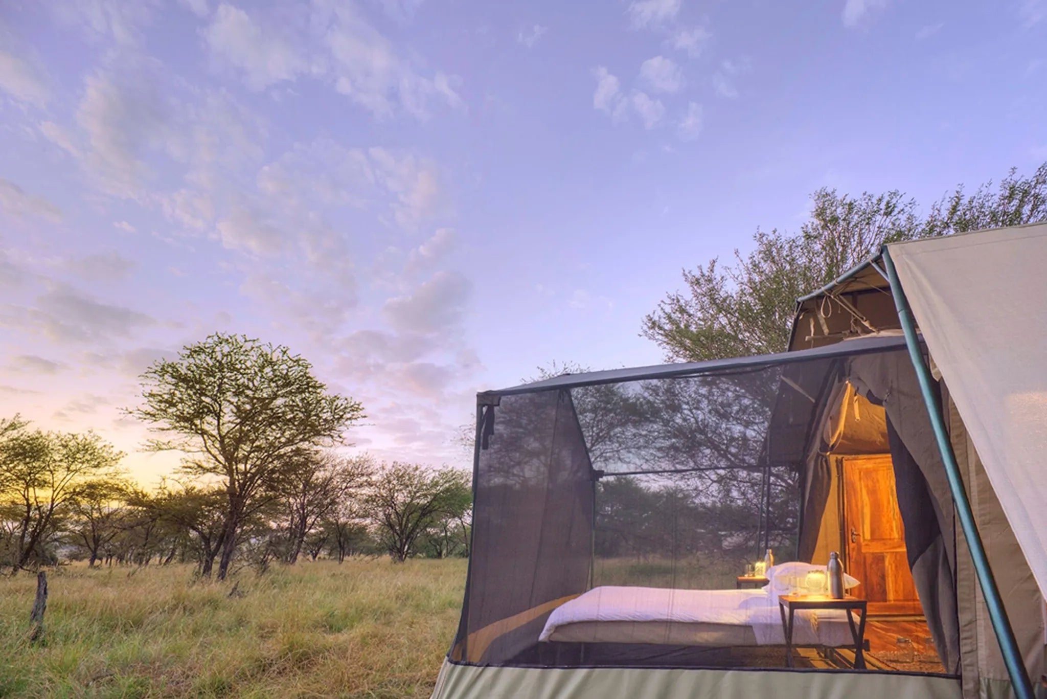 Olakira Camp - Bed on wheels, rolled out to the stargazing tent extension at Olakira Migration Camp - North (Jun - Oct), N...