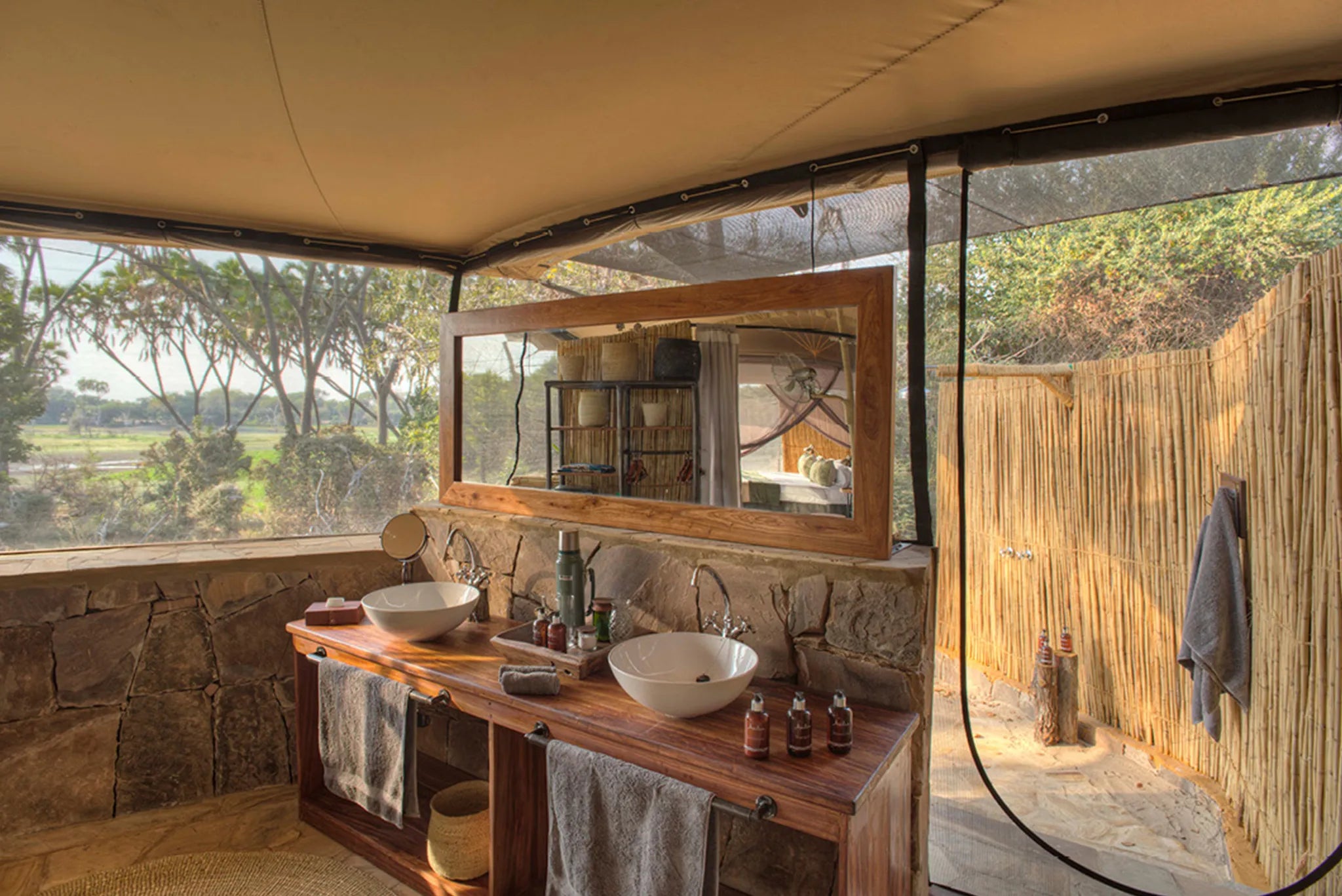 Roho ya Selous - Guest tent bathroom leading to outdoor shower at Roho Ya Selous, Nyerere National Park, Tanzania.