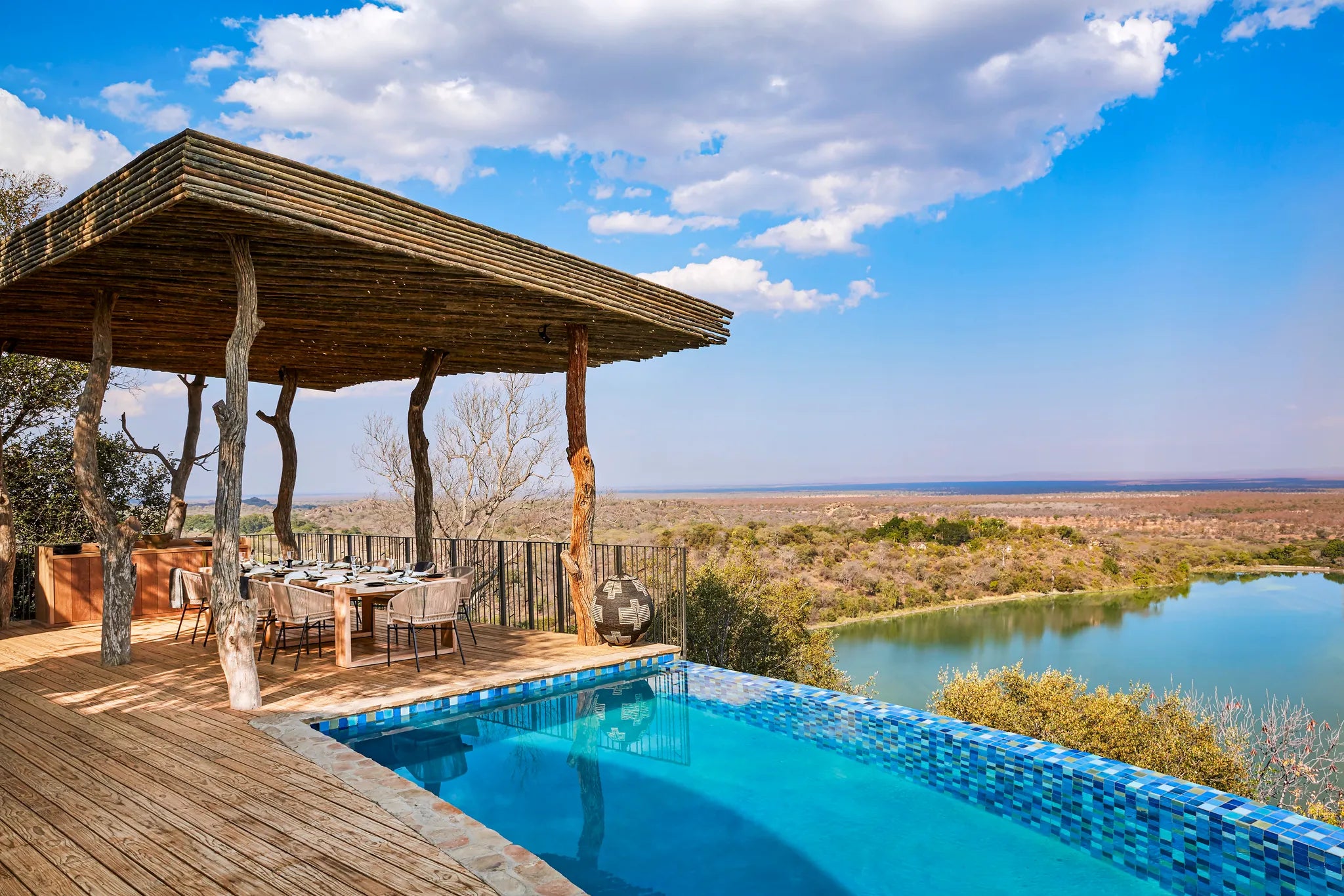 Singita Malilangwe House - Family dining and pool with a view at Singita Malilangwe House, Malilangwe Wildlife Reserve, Zi...