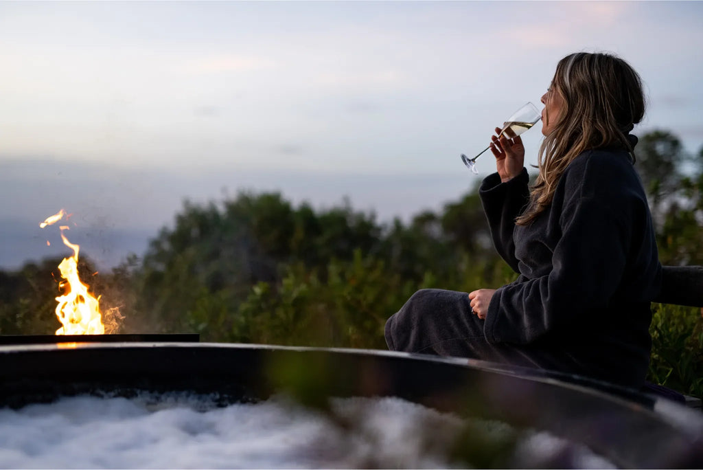 The Highlands - Guest Enjoying a Glass of Champagne at the Hot Tub at The Highlands, Ngorongoro Crater, Tanzania.