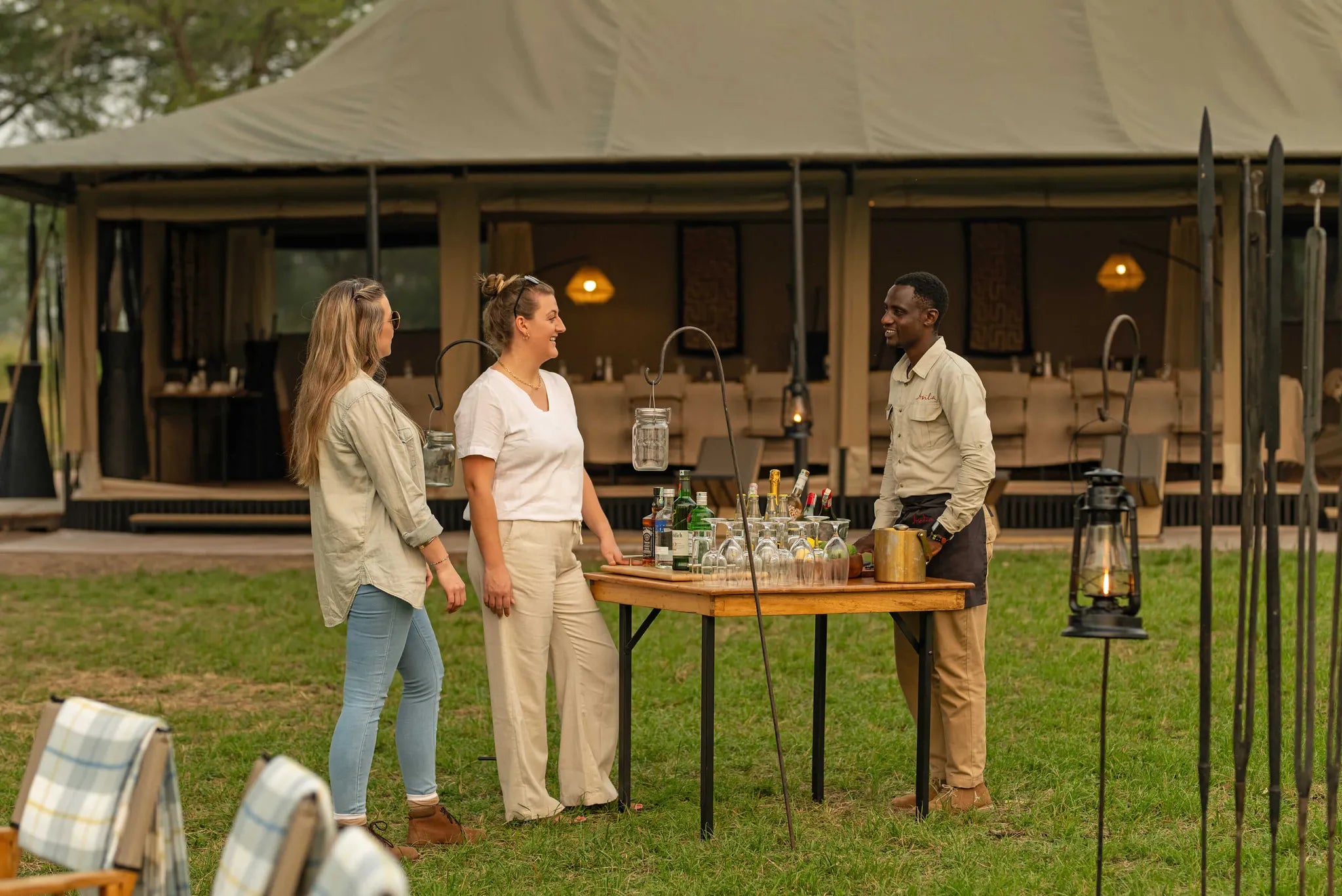 Ubuntu Camp - Guests chatting to waiter at Ubuntu Migration Camp - South (Dec - Mar), Southern Serengeti, Tanzania.